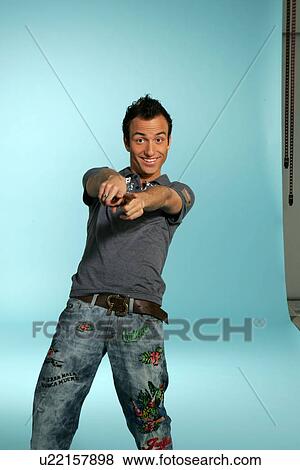 Young man in casual clothing, expressing happiness, studio shot View Large Photo Image Stock Photo - Young man in casual clothing, expressing happiness, studio shot. Fotosearch
