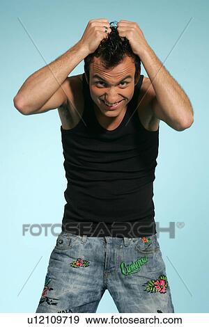 Young man in casual clothing, tearing his hair, studio shot View Large Photo Image Stock Photo - Young man in casual clothing, tearing his hair, studio shot. Fotosearch