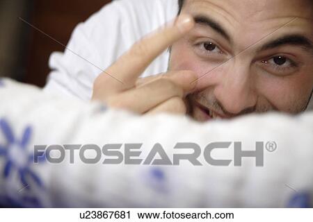 Young man lying in bed, laughing View Large Photo Image Stock Image - Young man lying in bed, laughing. Fotosearch