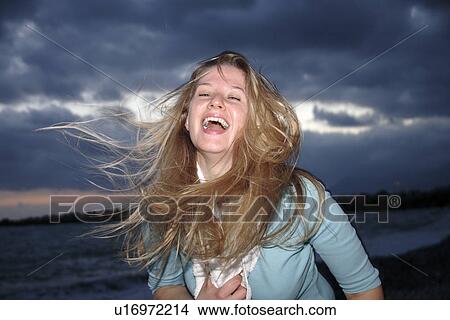 Young woman in a happy mood at the beach View Large Photo Image Picture - Young woman in a happy mood at the beach. Fotosearch