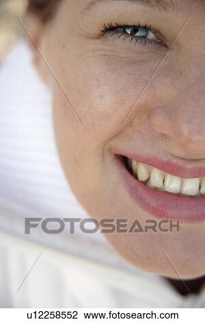 Young woman smiling, portrait, close up View Large Photo Image Stock Image - Young woman smiling, portrait, close up. Fotosearch