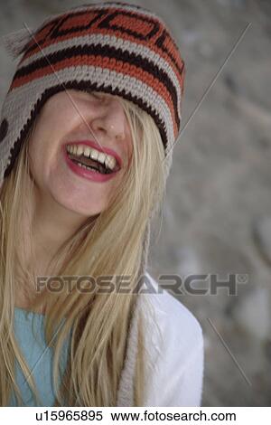 Stock Photography - Young woman wearing knitted cap, close up. Fotosearch