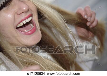Young woman wearing knitted cap, running and laughing at the beach, close up View Large Photo Image Picture - Young woman wearing knitted cap, running and laughing at the beach, close up. Fotosearch