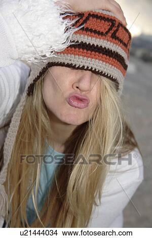 Young woman wearing knitted cap, running and laughing at the beach, close up View Large Photo Image Picture - Young woman wearing knitted cap, running and laughing at the beach, close up. Fotosearch