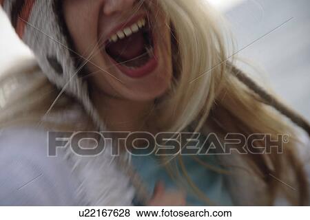 Young woman wearing knitted cap, running and laughing at the beach, close up View Large Photo Image Stock Photo - Young woman wearing knitted cap, running and laughing at the beach, close up. Fotosearch