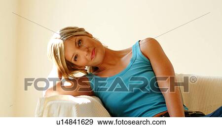 Woman relaxing on sofa View Large Photo Image Stock Photo - Woman relaxing on sofa. Fotosearch