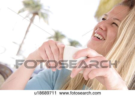 Young blond woman drinking cappuccino in a cafe, side view View Large Photo Image Stock Image - Young blond woman drinking cappuccino in a cafe, side view. Fotosearch