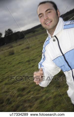 Young man jogging in spite of bad weather View Large Photo Image Stock Photo - Young man jogging in spite of bad weather. Fotosearch