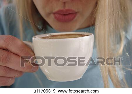 Woman drinking cup of cappuccino View Large Photo Image Stock Photo - Woman drinking cup of cappuccino. Fotosearch