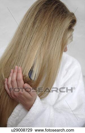 Woman with long blond hair using curling tongs View Large Photo Image Stock Photo - Woman with long blond hair using curling tongs. Fotosearch