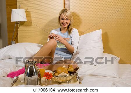 Young girl having breakfast in bed in her pajamas View Large Photo Image Picture - Young girl having breakfast in bed in her pajamas. Fotosearch