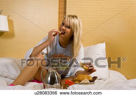 Young girl having breakfast in bed in her pajamas View Large Photo Image Stock Photograph - Young girl having breakfast in bed in her pajamas. Fotosearch