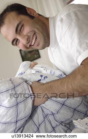 Picture - Young man in a pillow fight. Fotosearch