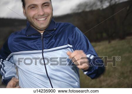 Young man jogging in spite of bad weather View Large Photo Image Stock Image - Young man jogging in spite of bad weather. Fotosearch
