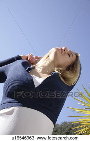 Young woman stretching outdoors, just woken up View Large Photo Image Stock Image - Young woman stretching outdoors, just woken up. Fotosearch