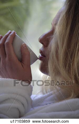 Woman in bathrobe drinking cup of tea, face profile View Large Photo Image Stock Photo - Woman in bathrobe drinking cup of tea, face profile. Fotosearch