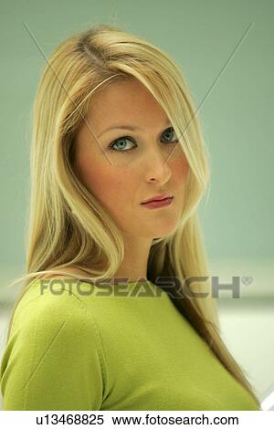 Portrait of young business woman with long blond hair wearing green sweater View Large Photo Image Stock Photography - Portrait of young business woman with long blond hair wearing green sweater. Fotosearch