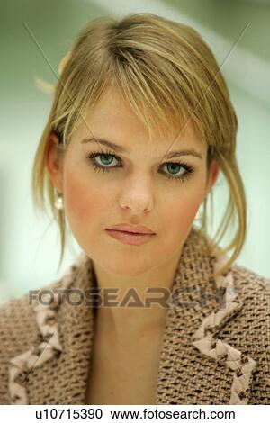 Stock Image - Portrait of young woman wearing business blazer. Fotosearch