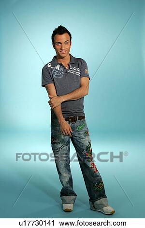 Stock Image - Young man in casual clothing, studio shot. Fotosearch