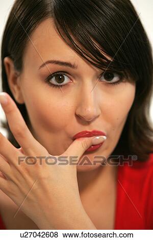 Stock Photo - Young woman eating bar of chocolate, portrait, close up. Fotosearch