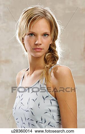 Young woman with long blond hair artfully braided, smiling, portrait View Large Photo Image Picture - Young woman with long blond hair artfully braided, smiling, portrait. Fotosearch