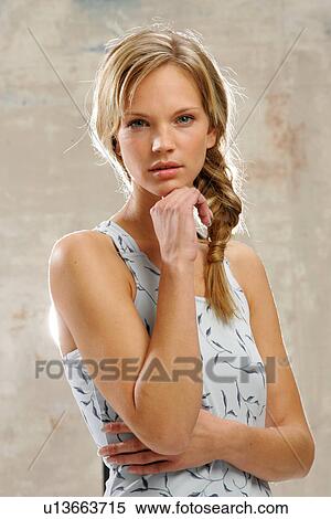 Young woman with long blond hair artfully braided, smiling, portrait View Large Photo Image Stock Photography - Young woman with long blond hair artfully braided, smiling, portrait. Fotosearch