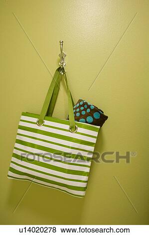 Stock Photo - Beach bag hanging on hook with beach towel. Fotosearch