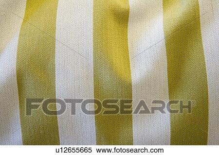 Stock Photography - Detail of green and white comforter, close up. Fotosearch