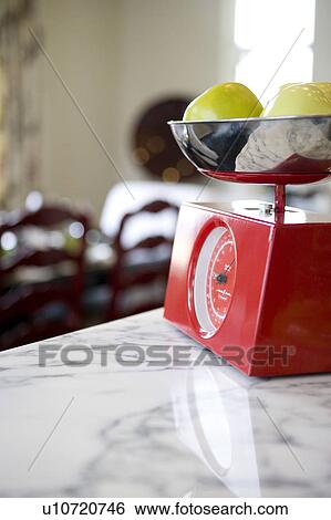 Stock Photograph - Green apples on kitchen scale. Fotosearch