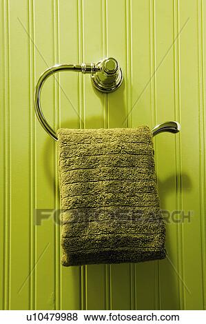 Stock Photo - Green Towel Hanging on Green Bathroom Wall. Fotosearch