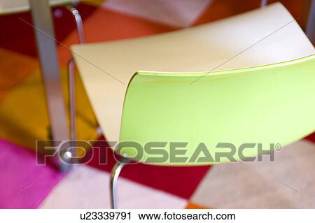 Modern green plastic chair on bright rug View Large Photo Image Stock Image - Modern green plastic chair on bright rug. Fotosearch