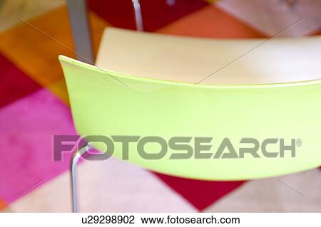 Modern green plastic chair on bright rug View Large Photo Image Stock Image - Modern green plastic chair on bright rug. Fotosearch