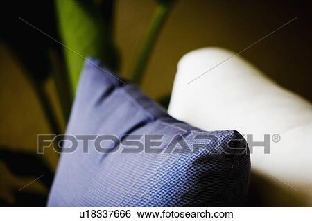 Stock Photograph - White cushion and blue pillow. Fotosearch