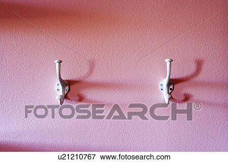 Stock Photo - White Hooks on Pink Wall. Fotosearch