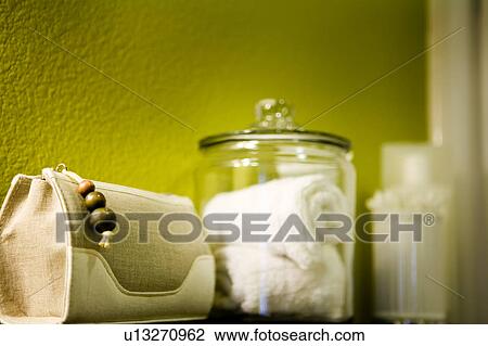 Stock Image - Display of Toiletries against Green Wall. Fotosearch