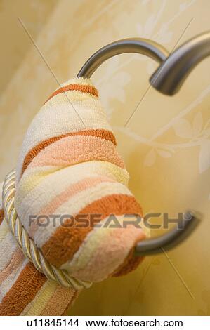 Picture - Striped orange and white towel on a rack. Fotosearch