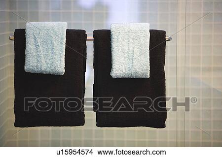 Picture - Towels Hanging from Glass Shower Door. Fotosearch