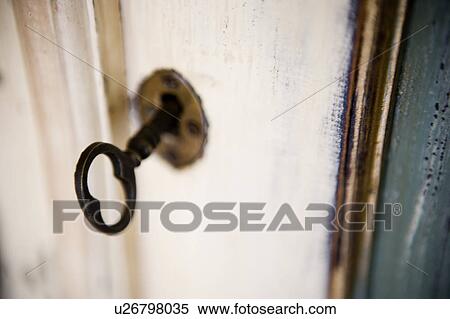 Aged key in keyhole View Large Photo Image Stock Photography - Aged key in keyhole. Fotosearch