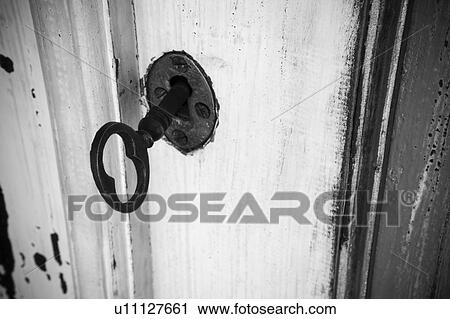 Black and white image of aged key in keyhole. View Large Photo Image Stock Image - Black and white image of aged key in keyhole.. Fotosearch