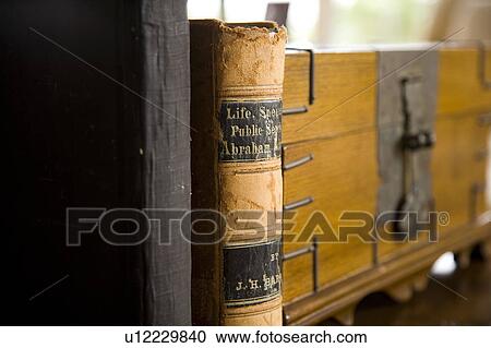 Stock Image - Detail of books next to wooden chest.. Fotosearch