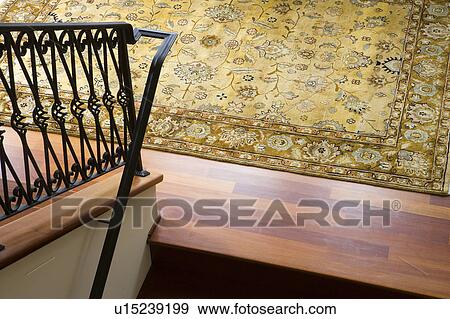 High perspective of wrought iron railing and area rug on wood floor. View Large Photo Image Stock Photo - High perspective of wrought iron railing and area rug on wood floor.. Fotosearch