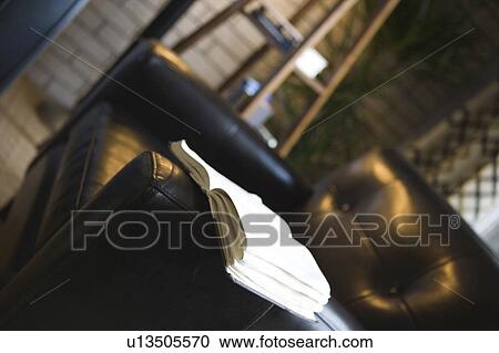 Detail of an open book resting on a leather arm chair View Large Photo Image Stock Image - Detail of an open book resting on a leather arm chair. Fotosearch
