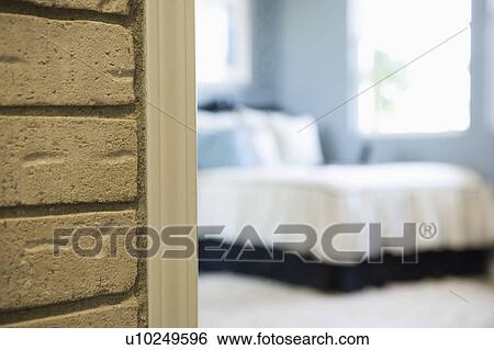 Detail of brick wall with bedroom in the background View Large Photo Image Stock Photograph - Detail of brick wall with bedroom in the background. Fotosearch
