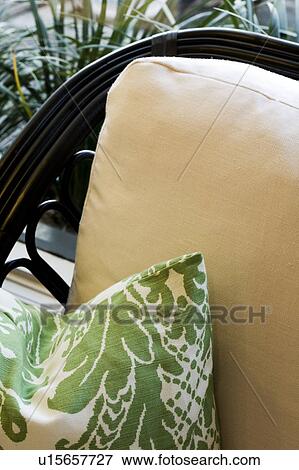 Green print pillow on wicker chair with white cushions View Large Photo Image Stock Photo - Green print pillow on wicker chair with white cushions. Fotosearch