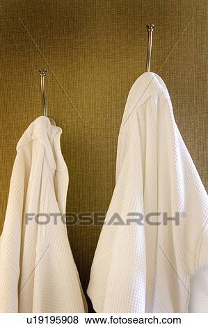 His and Hers White Bathrobes Hanging from Wall Hooks View Large Photo Image Stock Photo - His and Hers White Bathrobes Hanging from Wall Hooks. Fotosearch