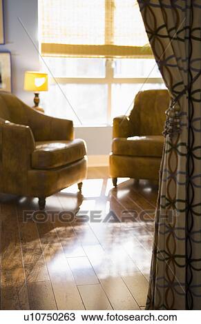 Stock Image - Leather armchairs and patterned curtain. Fotosearch