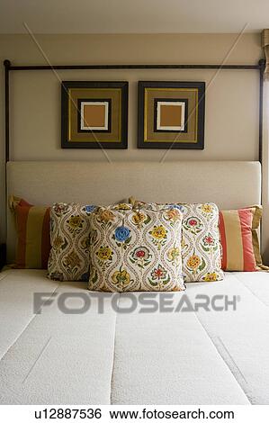 Symmetrical detail of decorative pillows on bed View Large Photo Image Stock Photograph - Symmetrical detail of decorative pillows on bed. Fotosearch