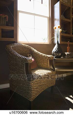 Stock Photograph - Wicker armchair with pillow. Fotosearch