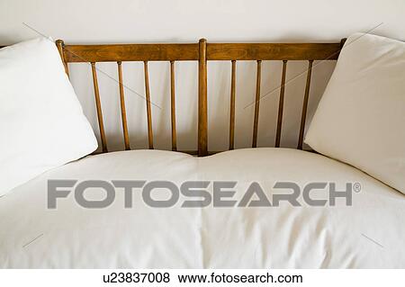 Wood couch with white cushions View Large Photo Image Stock Photo - Wood couch with white cushions. Fotosearch