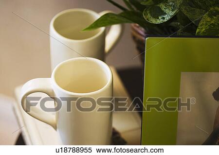 Stock Photography - Contemporary White Mugs on End Table. Fotosearch